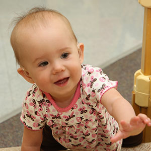 infant climbing three stairs
